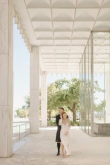 Bride and groom share a quiet moment outside of One Woodward in downtown Detroit in elegant editorial wedding photography in the city