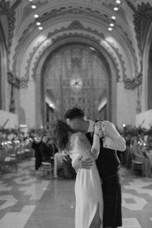 Black and white portrait of a bride and groom during their first dance in the lobby of the guardian building by Fine Art wedding photographer Heather Jowett