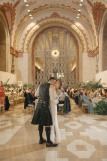Bride and groom embracing during their first dance in the lobby of the guardian building