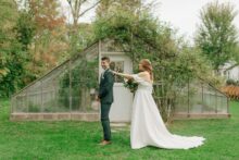First look between bride and groom outside the greenhouse at Glass House Community
