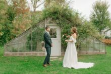 First look between bride and groom outside the greenhouse at Glass House Community