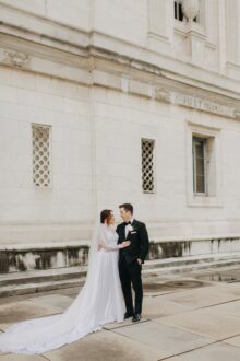 Luxury wedding portraits outside the Detroit Public Library where timeless architecture meets emotional storytelling for this elegant couple