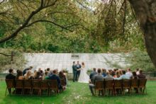 Wedding ceremony in front of the Glass House Community greenhouse