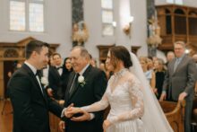 Cinematic documentary moment as brides father gives her away at Saints Peter and Paul Jesuit Church during a Detroit wedding filled with heirloom details and heartfelt emotion