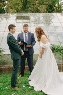 bride and groom laughting during their wedding cremony at glass house community