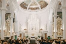 Wide shot of Saints Peter and Paul Jesuit Church interior during a wedding ceremony