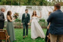 Bride laughs joyfully while walking up the aisle after saying I do