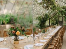 Close up of autumn floral centerpiece in a gold vase surrounded by taper candles and glassware in a romantic greenhouse setting