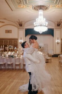 Black and white wedding photo of couple kissing on the grand staircase inside the Detroit Masonic Temple