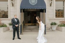 A bride lets out a heart laugh when seeing her groom during their first look.