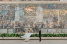 a couple's portrait in front of the murals at the DIA