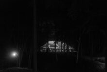 tented wedding reception from a distance at night
