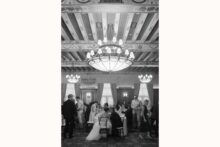 Bride and groom share a kiss during their wedding reception at the DAC photographed in a fine art documentary style