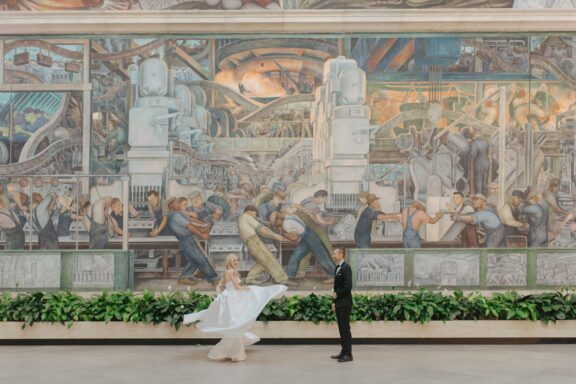 A portrait of a bride and groom is the Rivera Court of the DIA.