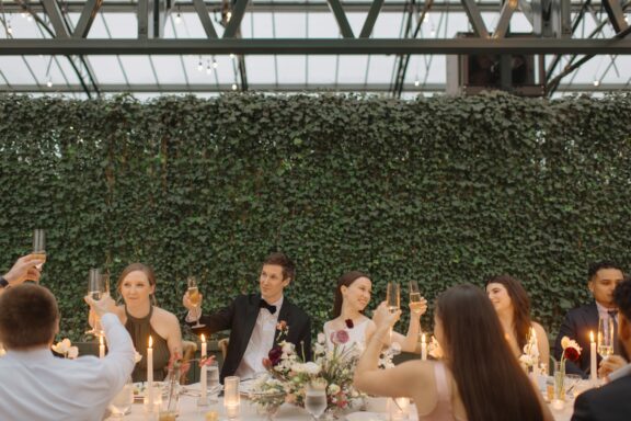 A bride and groom toasting during their Planterra wedding reception.