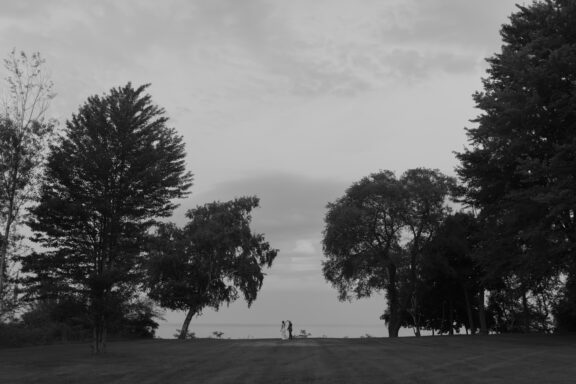 A bride and groom sharing a private dance on the shores of Lake Huron.