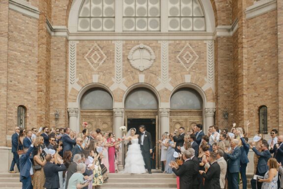 Bride and groom celebrate with their wedding guests upon exiting the church.