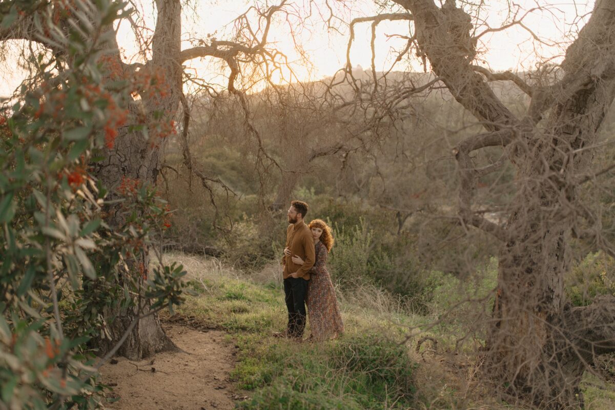 An engagement portrait of a couple at golden hour in the hills of Los Angeles.