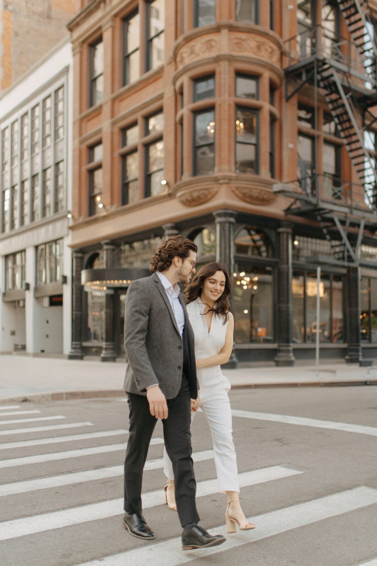 A couple walking the streets of Detroit hand in hand.