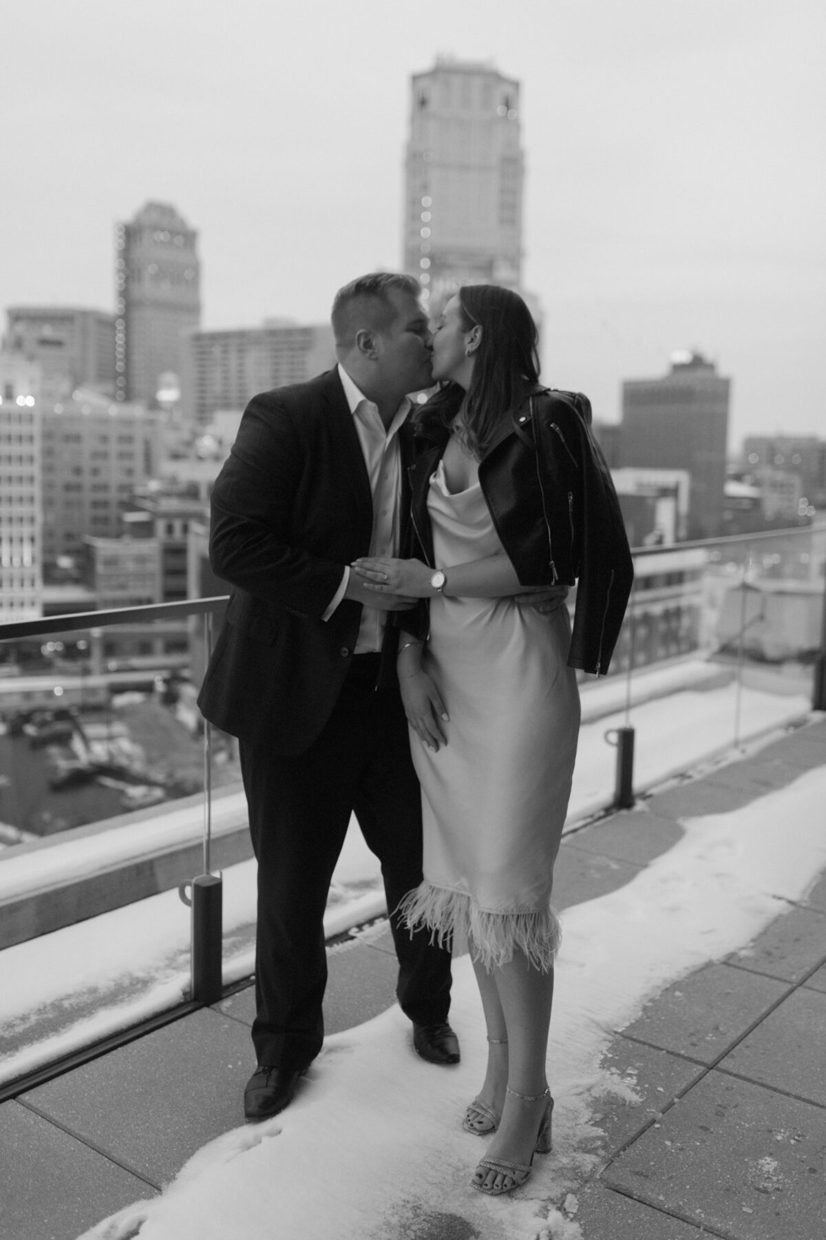 A couple on the rooftop of the DAC during their engagement session at the Detroit Athletic Club